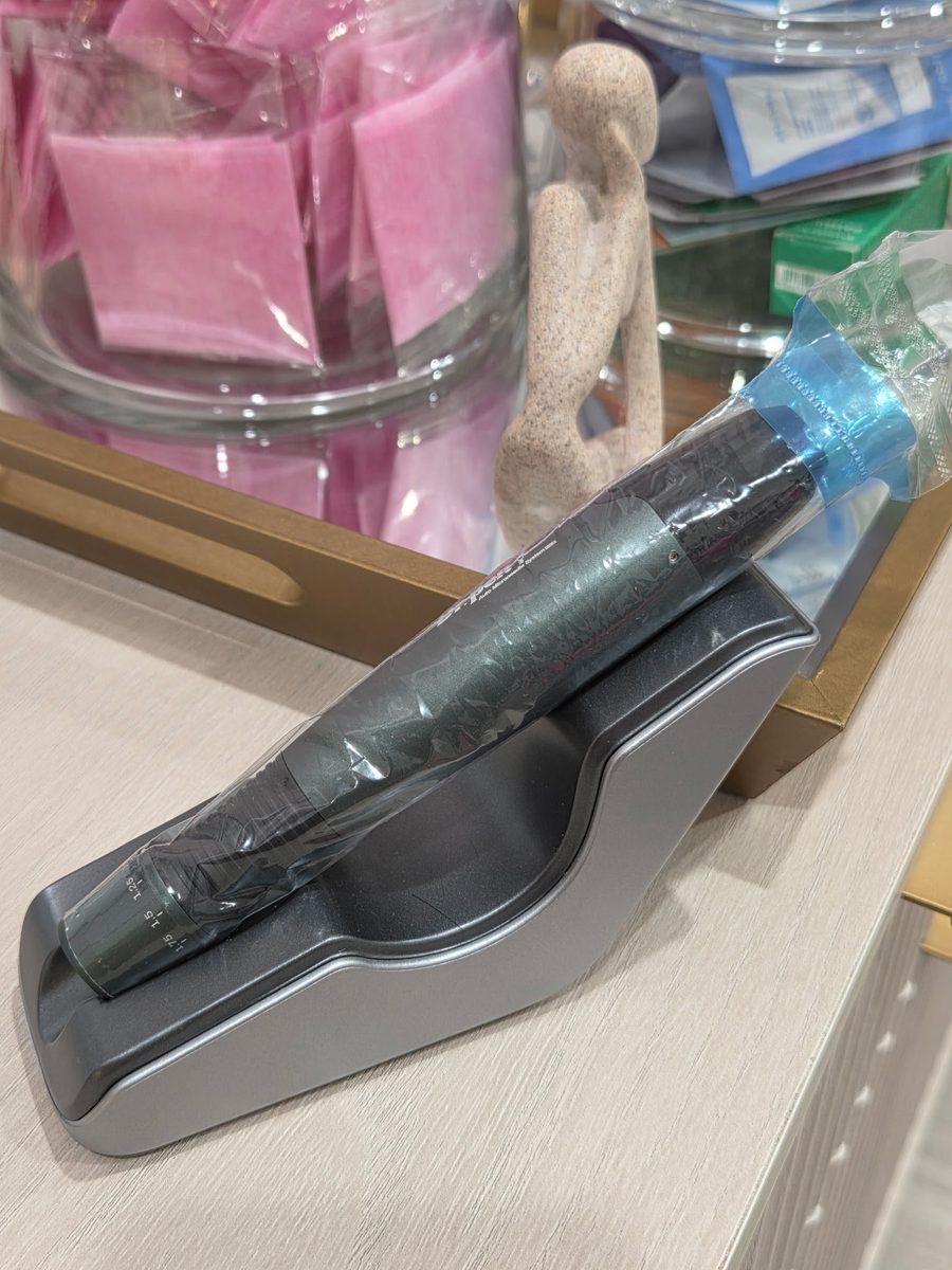 Automated microneedling pen in its cradle
