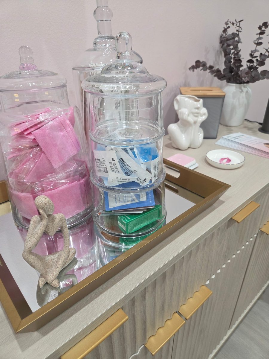 Apothecary jars of single-use supplies on the studio sideboard