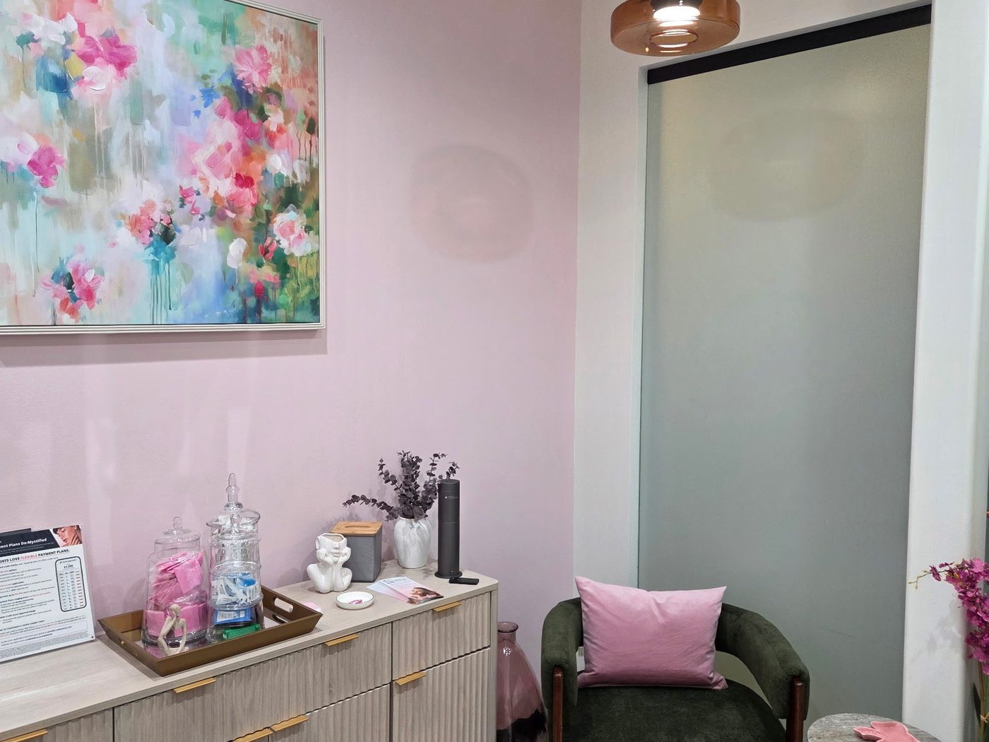 Consultation corner with green armchair and abstract floral painting